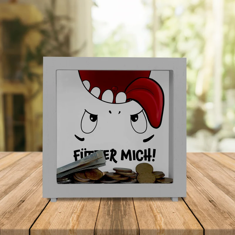 Spardose mit Comicfigur und lustigem Spruch - Fütter mich!